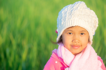 Portrait of young beautiful asian girl outdoor in winter with warm blured sunset light.