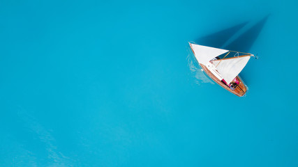 Yacht on the water surface from top view. Turquoise water background from top view. Summer seascape...