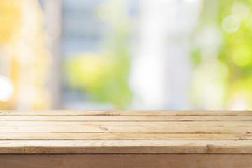 Empty wooden table  over abstract bokeh background