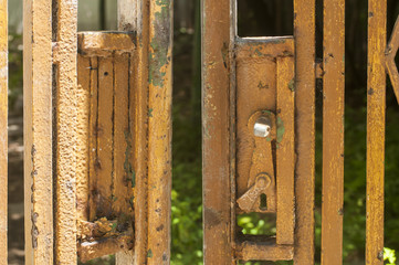 Old vintage weathered grunge broken damaged lock with broken handle of urban garden metal grid door