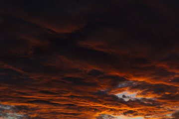 Clouds lit orange by sunset. Gradient from darker to brighter.