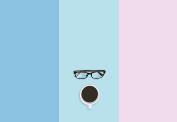 Coffee break concept, Eyeglasses and coffee on the pastel table top background with copy space.