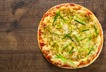 Pizza Margherita or Margarita with Mozzarella cheese. Italian pizza on wooden background