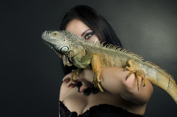 perfect portrait sensual girl and iguana in the studio
