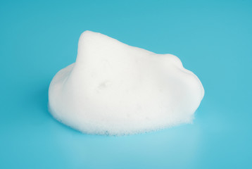 Soap foam bubble isolated on blue background object beatuy health care concept