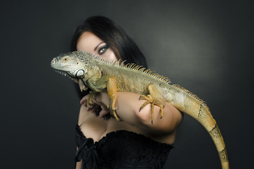 perfect portrait sensual girl and iguana in the studio
