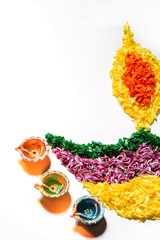 Diwali  Rangoli made in shape of Diya with colorful flowers