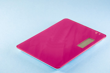 Magenta Digital Kitchen Scale isolated on blue background