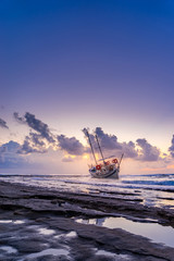 Fishing boat shipwreck or abandoned shipwreck. , Wrecked boat abandoned stand on beach in RHodes