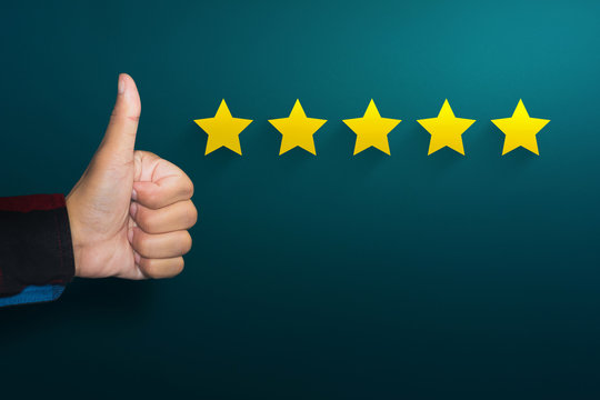 Customer service experience and satisfaction survey concept with businessman shows an excellent mark with a thumb up and five star rating
