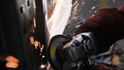 close view technician grinds lorry metal body in workshop