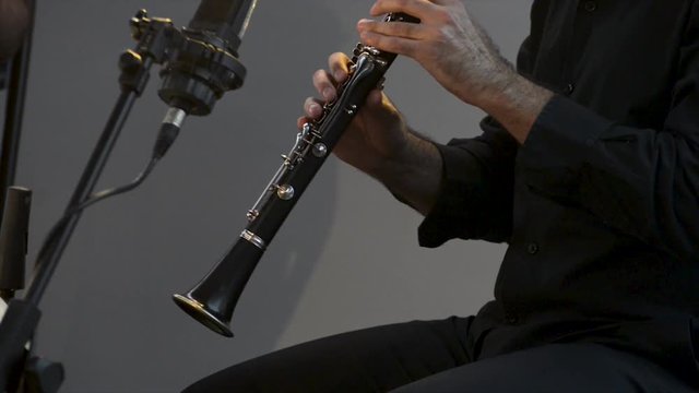 Clarinetist at a concert, theater scene, clarinet, flat plane closeup