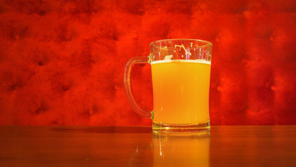 Beer mug over red velvet background, restaurant