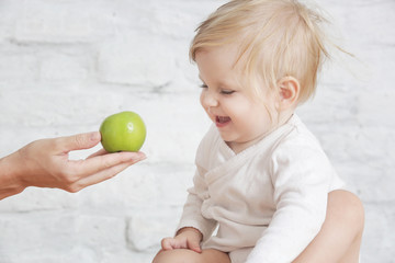 Fototapeta na wymiar Fresh organic apple as perfect healthy finger food for little ones