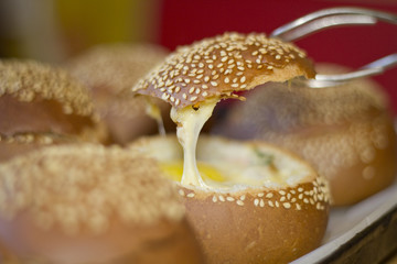 Buns with liquid egg, bacon and melted cheese.Egg, cheese and bacon sandwiches. Hot breakfast.