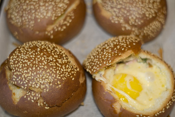 Buns with liquid egg, bacon and melted cheese.Egg, cheese and bacon sandwiches. Hot breakfast.
