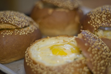 Buns with liquid egg, bacon and melted cheese.Egg, cheese and bacon sandwiches. Hot breakfast.