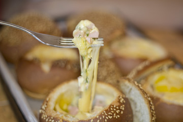 Buns with liquid egg, bacon and melted cheese.Egg, cheese and bacon sandwiches. Hot breakfast.