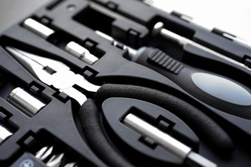 Small tool-kit with basic tools screw driver, tapered nose pliers & spanner for home improvement