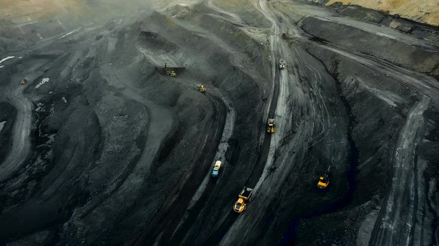 Drone aerial quarry shot. Industrial vehicles overall plan. Modern mining.