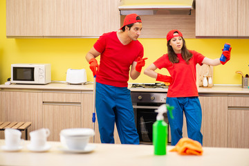 Cleaning professional contractors working at kitchen