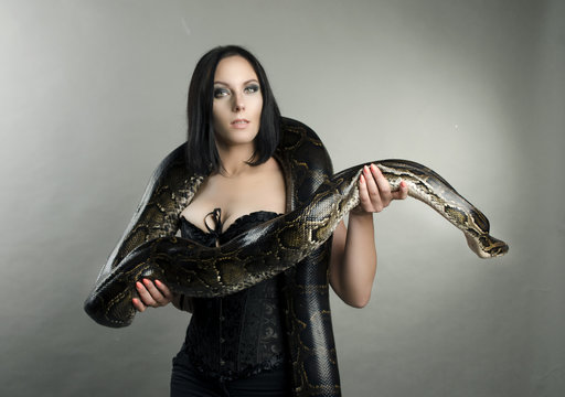 sensual brunette woman and snake
