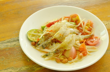 Som tum Thai spicy green papaya topping raw shrimp salad on plate