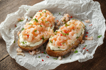 Prawns, shrimp seafood bruschetta with creamy cheese, parsley and chili