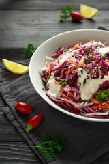 Coleslaw salad with red, white cabbage, carrot, parsley, sesame seeds. served with mayonnaise and lemon