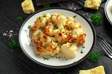 Roasted cauliflower with cheddar cheese sauce and herbs.