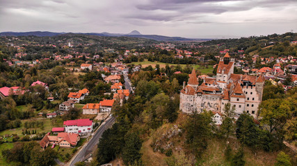 Aerial view of Bran castle in beautiful Transylvania, region of Romania. Cloudy day with dark clouds