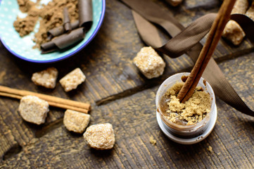 Making homemade beauty treatment for healthy skin and lips in autumn pot of cocoa cinnamon and honey lip scrub DIY homemade beauty ideas