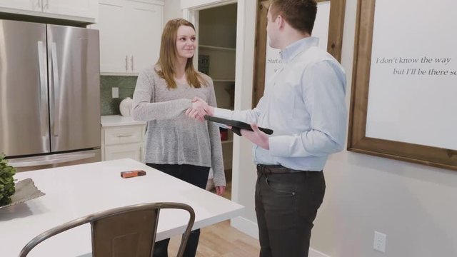 Customer shakes hands with a contractor to work on her home improvements