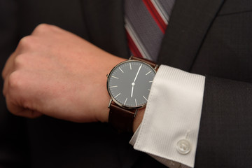 businessman in suit, tie and wrist watch