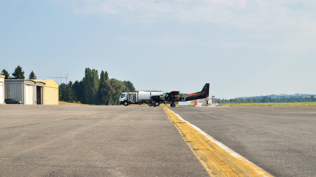 A plane refueling on an airfield