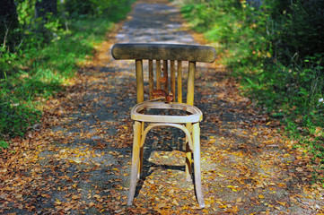 Wooedn chair on the asphalt road