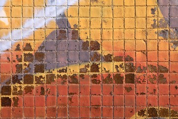 Painted mosaic brick tile wall, close up of graffiti texture, with vibrant colors for creativity, imaginative backgrounds and ideas.