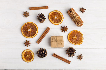 Kraft paper gifts and spices on a white table. The original decor for Christmas. Beautiful layout, top view, flat lay.