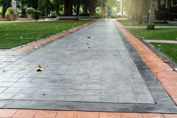 Printed concrete texture and green artificial grass.