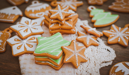 Christmas homemade gingerbread house cookie over wooden background. Sweets as a gift for the new year. free space free space greetings