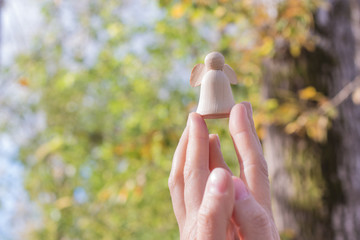 Wooden guardian angel prayer holding hands