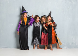 Group of friends with costumes of vampires and witches for halloween holidays making a joke