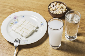 Turkish raki with cheese and cookies on wooden table