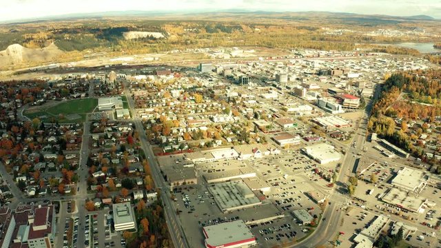A cinematic, aerial view of the city of Prince George downtown area, including a residential section as well as the main downtown core during the autumn / fall season.