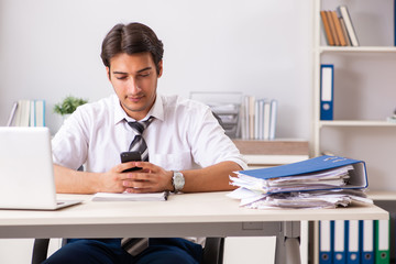 Fototapeta premium Young handsome businessman working in office