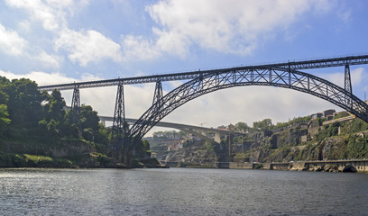 Maria Pia Bridge over the Douro river, Porto, Portugal. Panoramic view from the water. A great place for tourist trips.