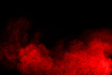 abstract red powder explosion on black background.abstract red powder splatted on black background. Freeze motion of red powder exploding.