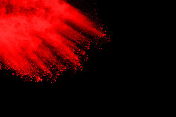 abstract red powder explosion on black background.abstract red powder splatted on black background....