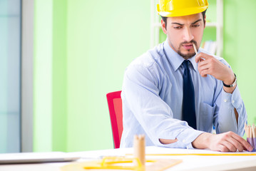 Young male architect working at the project