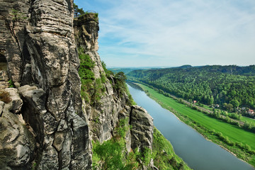Fototapeta na wymiar View from the cliff to the river valley in Saxon Switzerland National park, popular travel destination in Germany